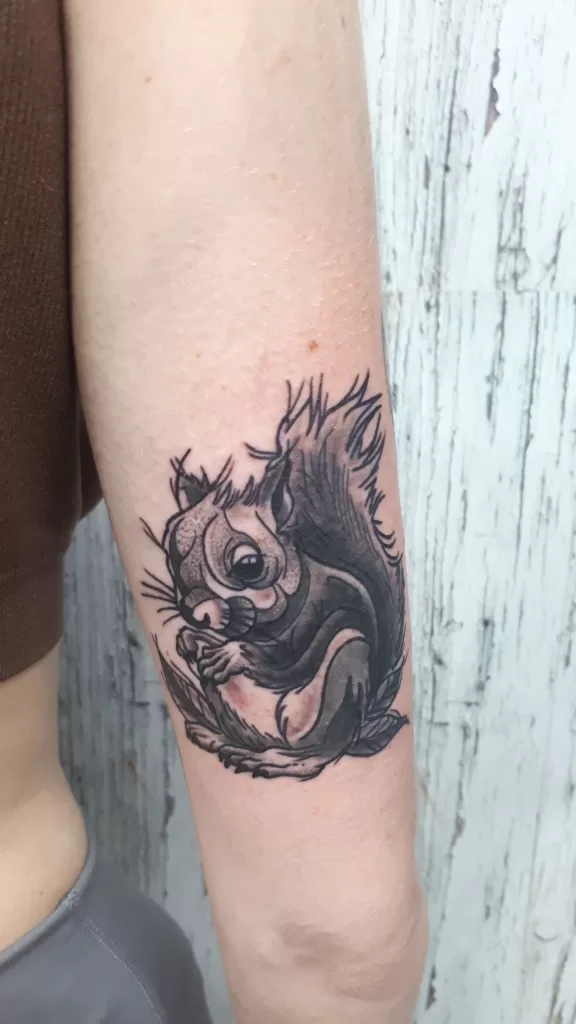 black and grey squirrel on arm