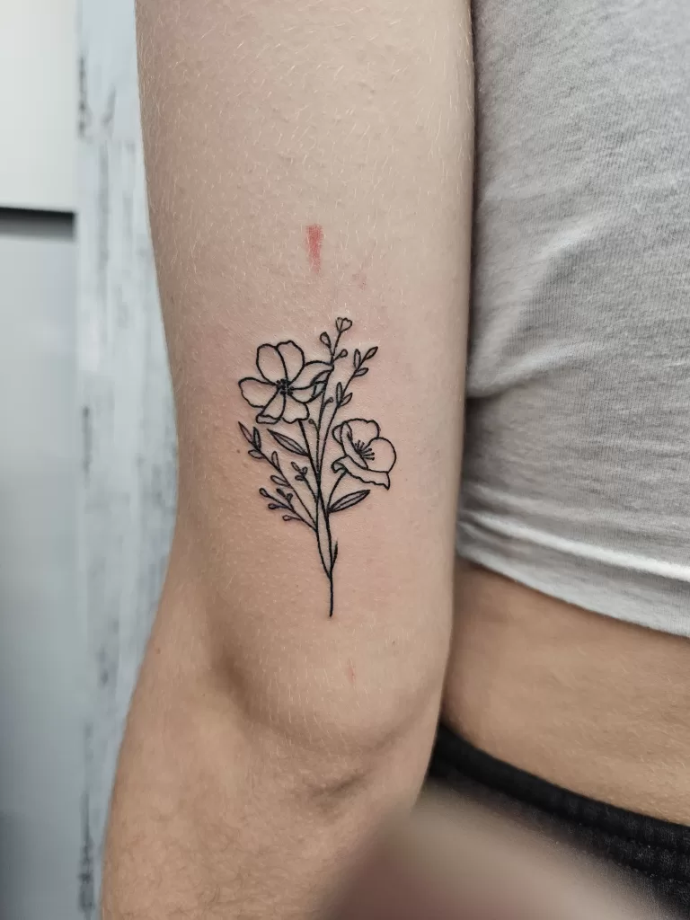 Fineline tattoo of floral bouquet