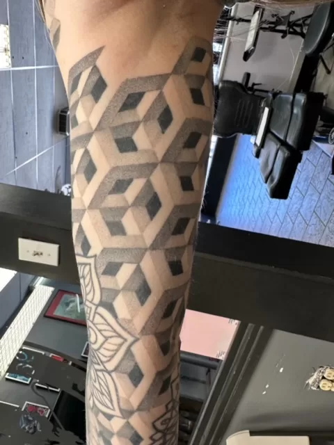 black and grey custom geometric sleeve tattoo