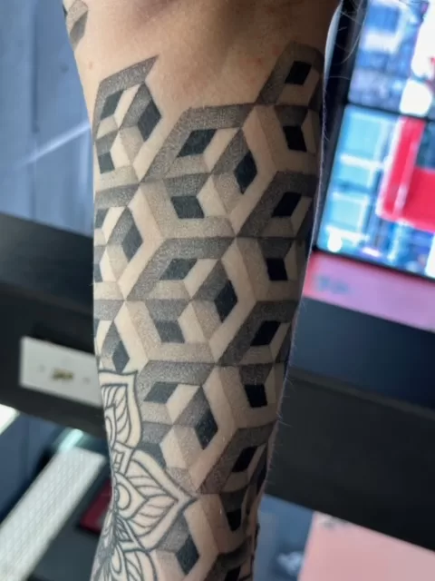 black and grey custom geometric sleeve tattoo