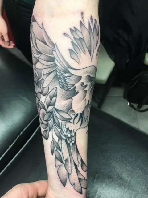 bird with flowers black and grey tattoo