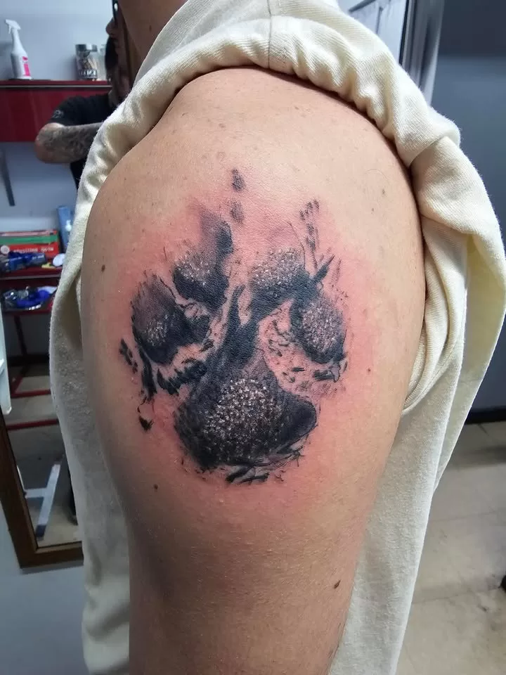 black and grey paw print tattoo